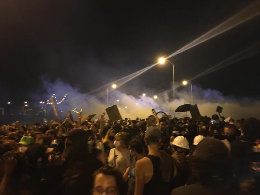Tear gas deployed by New Orleans Police Department officers floats into a crowd of protesters on the Crescent City Connection in New Orleans. June 3, 2020.