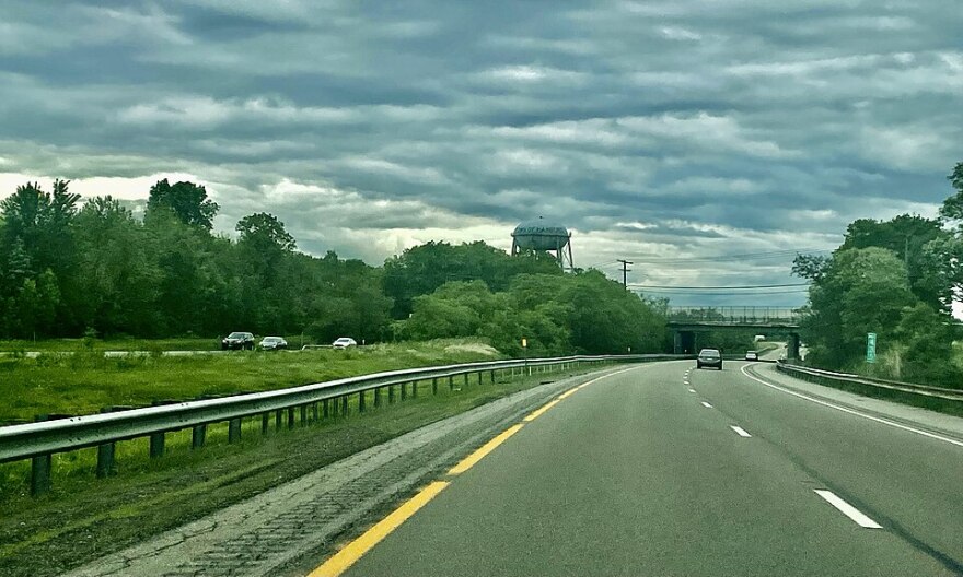 The Town of Hamburg's municipal water tower looms in the distance while passing along the eastbound New York State Thruway between exits 57 and 56, as seen on a May 2022 afternoon.