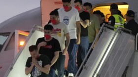 Migrants deported months ago by the United States to El Salvador under the Trump administration's immigration crackdown arrive at Simon Bolívar International Airport in Maiquetia, Venezuela, Friday, July 18, 2025. (AP Photo/Ariana Cubillos)