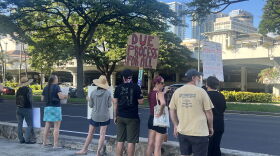 A protester in Honolulu holds a sign reading, "Due process for all," on Jan. 25, 2026.