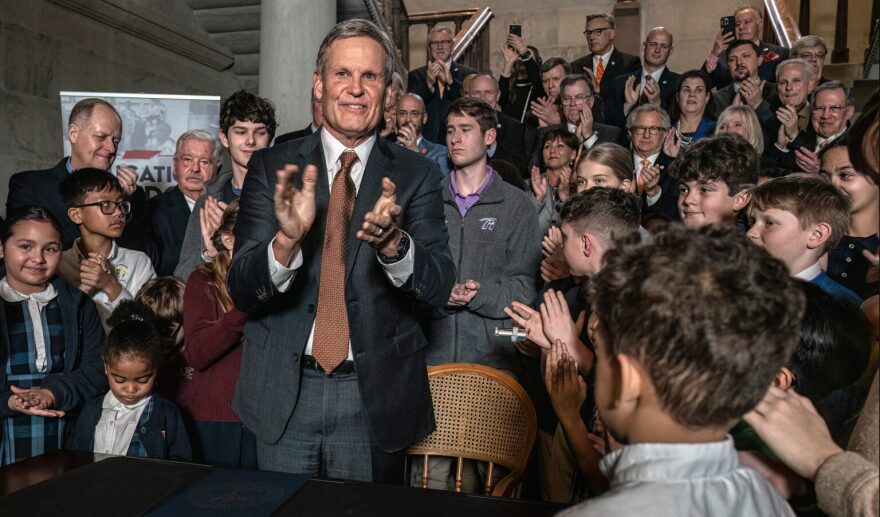 Gov. Bill Lee applauds after signing a universal school voucher measure into law on Feb. 12, 2025.