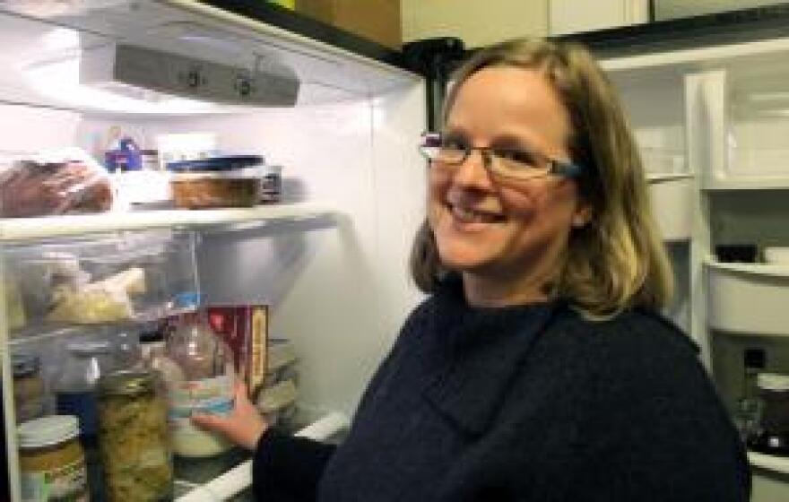 Jill Lucht, of Columbia, Mo., reads the ingredient lists on the food in her refrigerator.