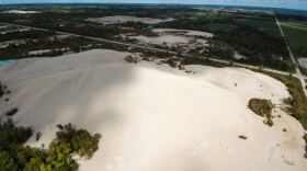An aerial photo shows hills of mining waste known as "chat" scattered throughout the abandoned lead and zinc mine at the Tar Creek Superfund site.
