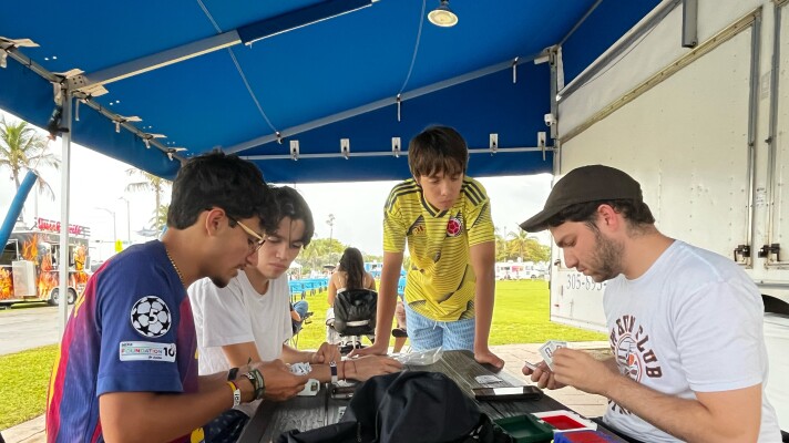 A group of young men gather at Haulover Park in Miami Beach to trade Panini stickers in May 2026 ahead of the World Cup.