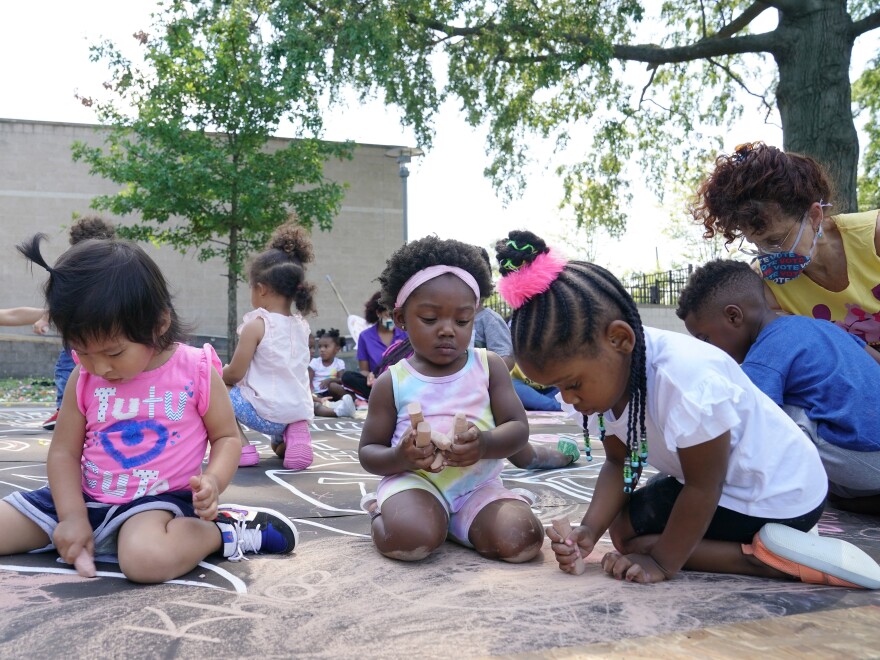 Children and teachers from the KU Kids Deanwood Child Care Center complete a mural in celebration of the launch of the Child Tax Credit on July 14 in Washington, D.C. Tens of millions of parents have received their first monthly child tax credit payment, but it might make sense to opt out of the rest of the payments and wait until next year to claim the credit in full.