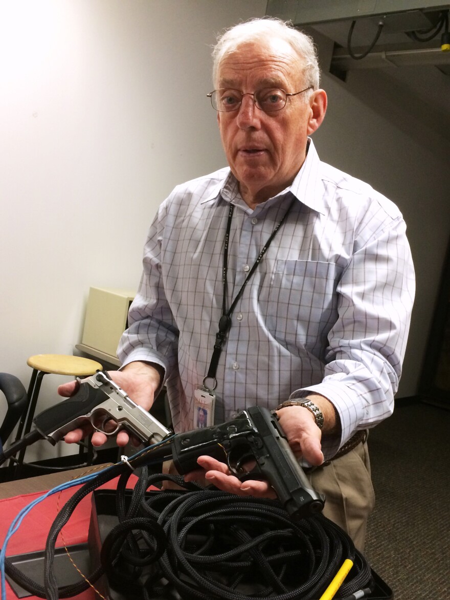 William Marshall of the New Jersey Institute of Technology with two specially modified guns used for research on grip sensor technology.