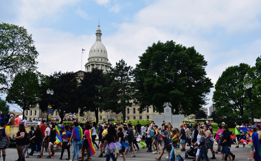 People marching in front of the capitol building in Lansing, Michigan