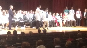 Student receiving a white coat at the first ever white coats ceremony for the New York Institute of Technology College of Osteopathic Medicine at Arkansas State University