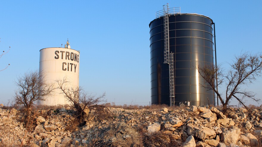 A new water tank in Strong City, Kan., (at right) sits next to one that was part of an old leaky system on a hill just outside the city limits.