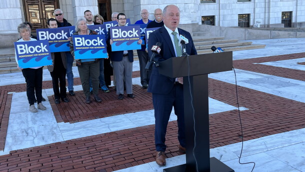 Independent gubernatorial candidate Ken Block speaks at a news conference outside the Rhode Island State House in Providence on Monday, Oct. 26, 2026, as supporters stand behind him. Block outlined 17 policy priorities and pledged not to undermine the Affordable Care Act if elected governor. Credit: Ian Donnis/Ocean State Media