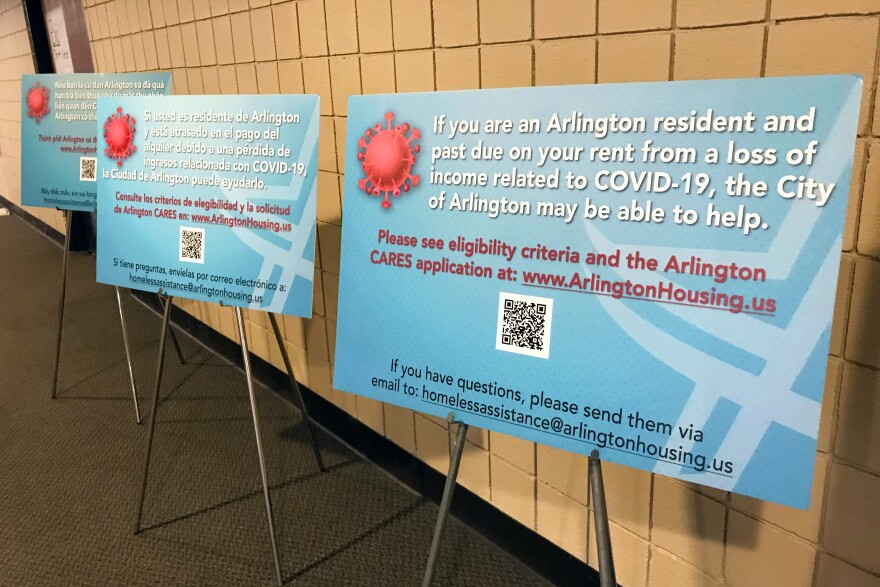 Blue signs in a hallway advertise a rental assistance program.