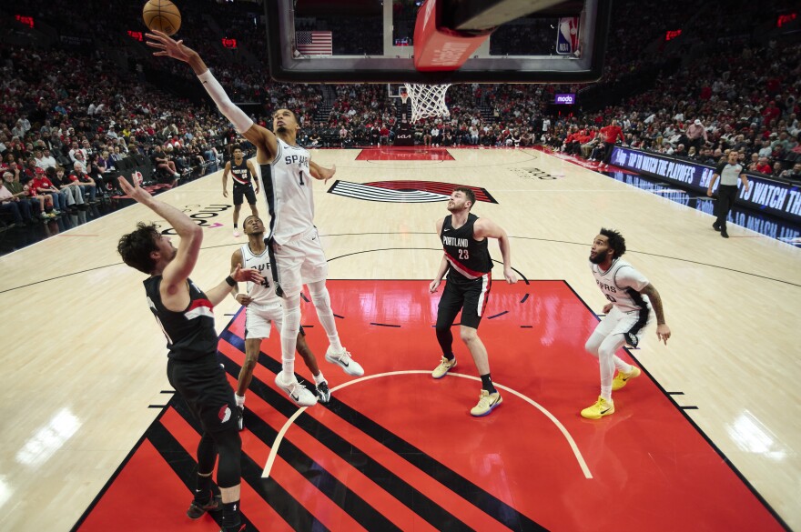 Apr 26, 2026; Portland, Oregon, USA; San Antonio Spurs forward Victor Wembanyama (1) blocks a shot during the second half against Portland Trail Blazers forward Deni Avdija (8) during game four of the first round of the 2026 NBA Playoffs at Moda Center.