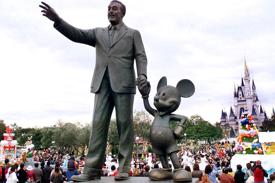 Walt Disney and Mickey Mouse statues stand at the