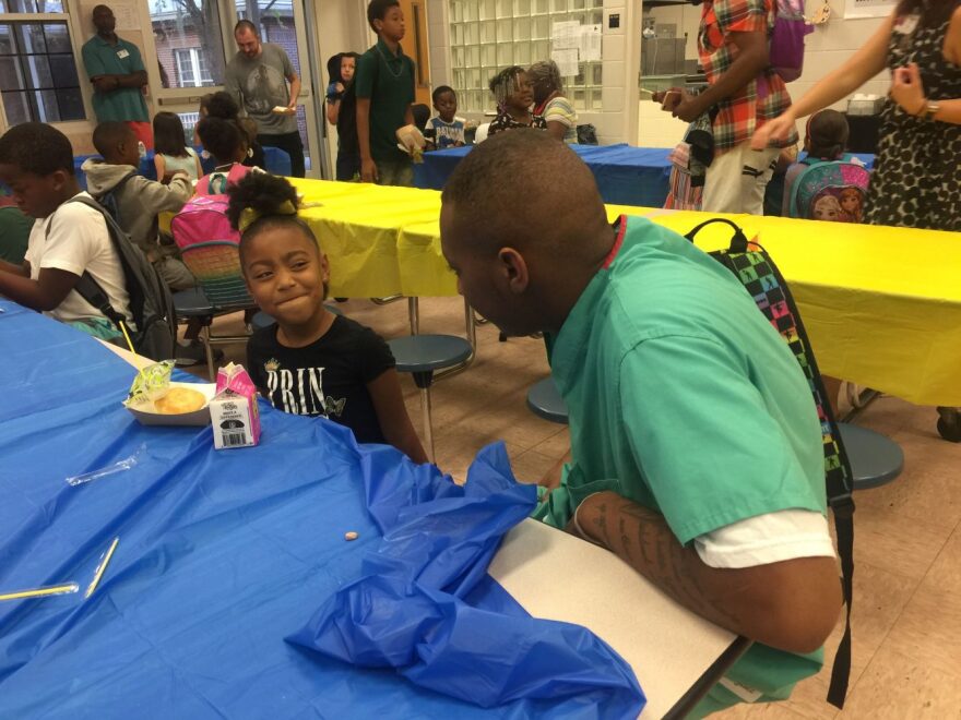 David Franklin stares at his niece Ariah as she gives him a questioning look. Franklin said he wants her to get a good education, so she can achieve great things in life. (Dana Bryan/WUFT News)