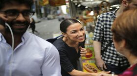 Alexandria Ocasio-Cortez greets a reporter near Rockefeller Center in New York, Wednesday, June 27, 2018.
