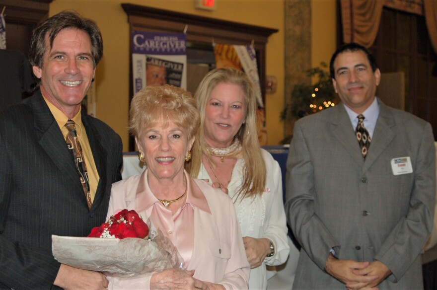 Gary Barg, founder of caregiver magazine, stands by his family members to his right.