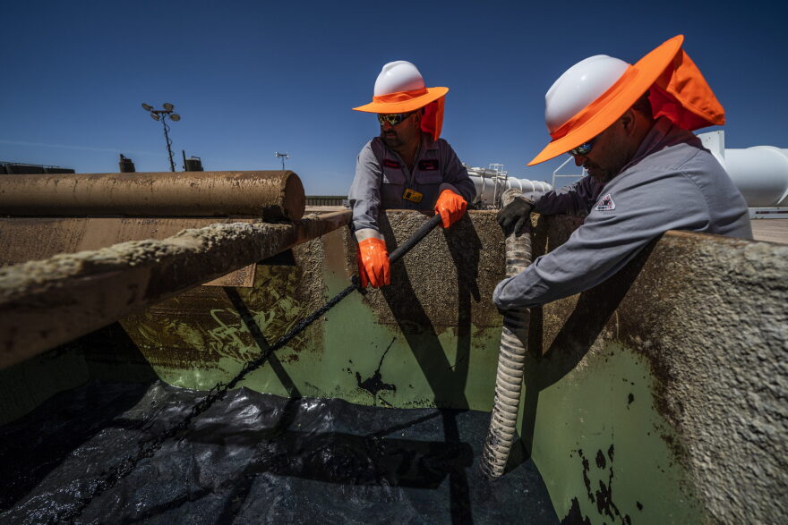 MIDLAND, TX - MAY 5: Workers extracting oil from oil wells in the Permian Basin in Midland, Texas on May 5, 2018. Oil production has been causing a sudden influx of money especially for local Texans despite the consequences to the natural environment.