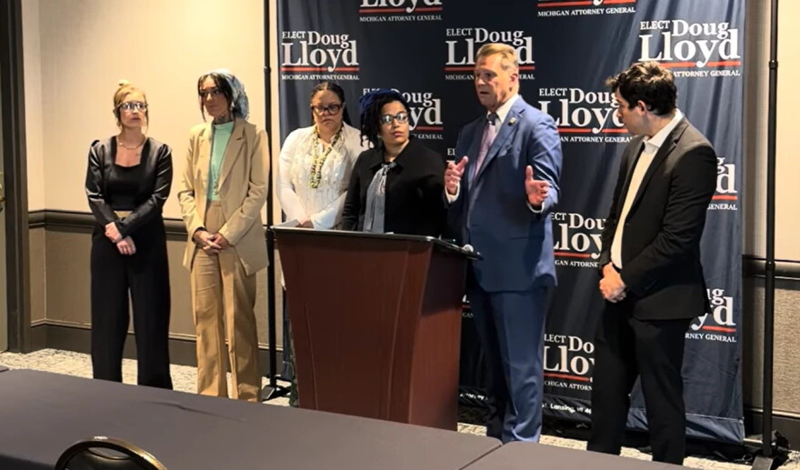 Eaton County Prosecuting Attorney, Republican Doug Lloyd (second from the right), criticizes his Democratic opponent in the race for Michigan attorney general for advocating a policy that "ignores the realities of the sex trade."