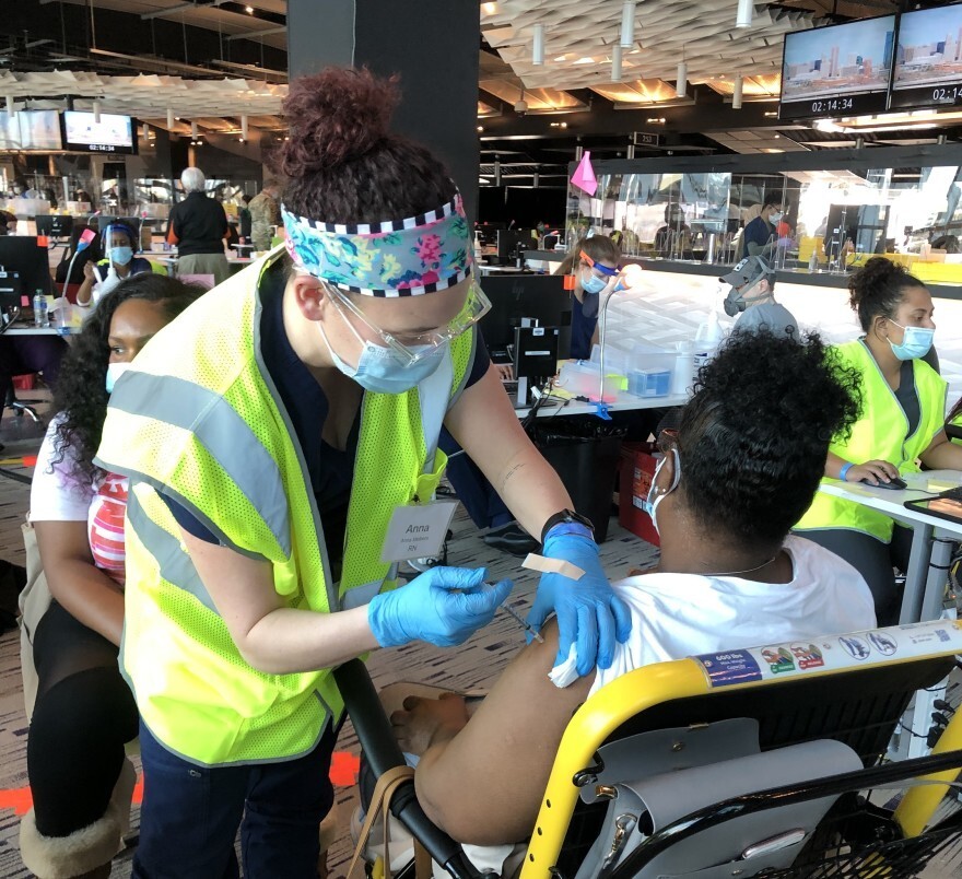 A resident receiving the Pfizer COVID-19 vaccine at the M&T Bank Stadium this spring. Credit: Sarah Y. Kim/WYPR