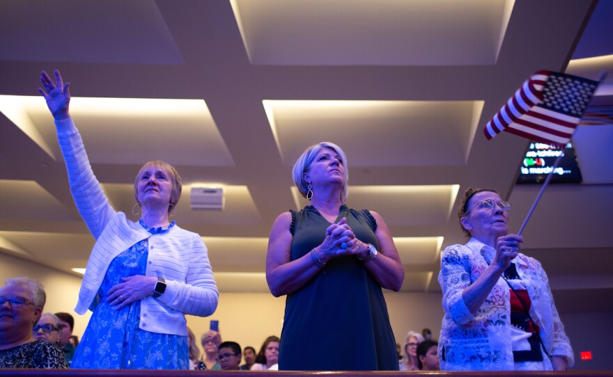 Churchgoers rise as performer Lee Greenwood sings “The Battle Hymn of the Republic” at First Baptist Dallas. Shortly afterwards, pastor Robert Jeffress delivered a sermon celebrating the Supreme Court's decision to overturn Roe v. Wade.