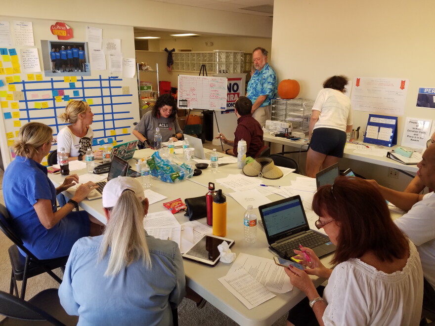 Volunteers at a former Democratic candidate David Holden's headquarters on Thursday try to connect provisional voters with their ballots. 