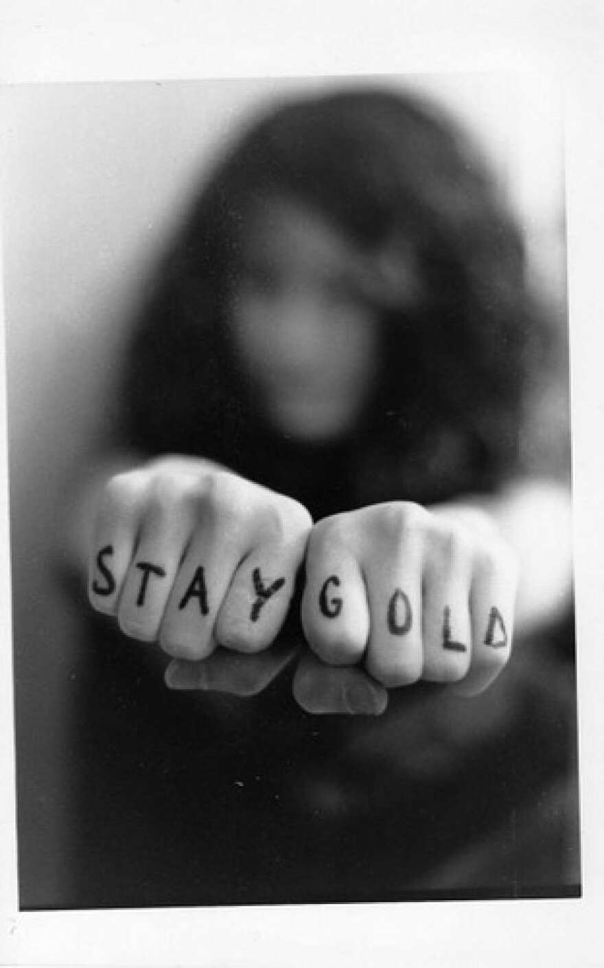 Stay Gold, written on a woman's fists.