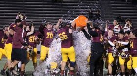 Arlington High School football players celebrating after a game victory.