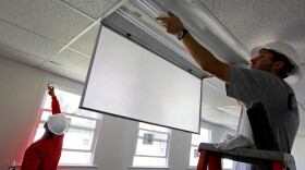 Most of Indiana's clean energy jobs are in energy efficiency. In this photo, construction workers install new energy-efficient windows and lighting in a naval center in California, 2010.