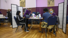 Several people get the COVID-19 vaccine at a mass clinic at the Corinthian Baptist Church in Des Moines.