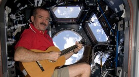 Canadian Space Agency (CSA) Chris Hadfield, Expedition 34 Flight Engineer, playing guitar in the Cupola Module. Photo was taken during Expedition 34 December 25th, 2012.