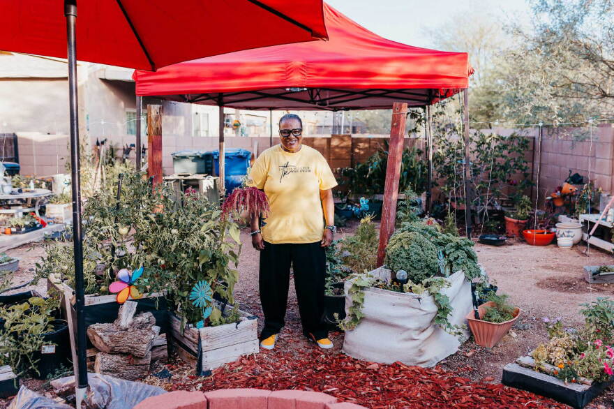 Alex stands in garden