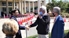 Florida Gov. Ron DeSantis greets Ocala Mayor Kent Guinn, center, and On Top of the World Communities President Ken Colen at a vaccination event at OTOW on Friday. Photo: Joe Byrnes