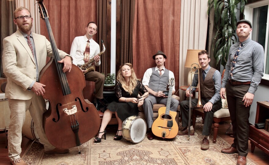 the bandmates posing with their instruments inside