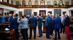 Members of the Texas House of Representatives converse with one another 