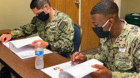 U.S. Navy Hospital Corpsman 2nd Class Ryon Kumrow (right) and Jose Naranjo (left), advanced radiology technologists from Naval Hospital Pensacola, review training material during orientation at Valley Baptist Medical Center- Harlingen.
