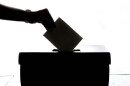 Ballot box with vote being cast image