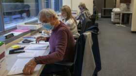 People at the Division of Elections double-check voter information on August 25, 2020 in Juneau, Alaska. (Photo by Rashah McChesney/KTOO)