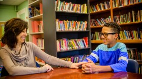 A school guidance counselor talks to a student.
