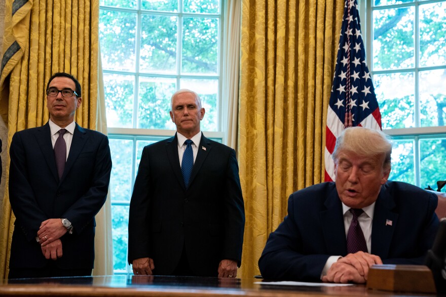 President Trump, flanked by Treasury Secretary Steven Mnuchin (left) and Vice President Pence last month in the Oval Office. Pence and Mnuchin are in the immediate line of succession if Trump is not able to perform his duties.