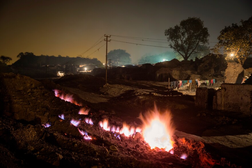 An underground fire has been burning for at least a century, according to villagers in Boka Pahari, on the outskirts of Jharia city. The fire, shown here in 2014, is some 200 yards from the village and is said to have started when abandoned coal mines were not properly closed.
