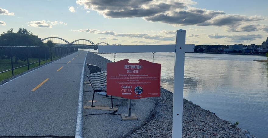 The new Dred Scott marker is the 26th destination for QC PastPort since 2021, located on the Great River Trail in Rock Island, east of Schwiebert Park, near the Arsenal Bridge.