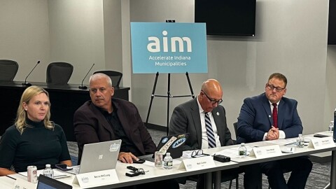 Matt Greller, the CEO of Accelerate Indiana Municipalities, second to left, lead a discussion with more than a dozen leaders of towns and cities at the Speedway Municipal Center on Wednesday, Nov. 12, 2025.