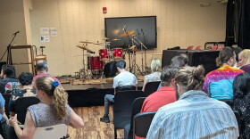 The expectant crowd waits as the competitors get ready to demonstrate their skills behind a massive drum set