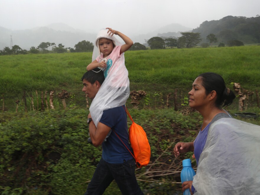 People in a migrant caravan make their way towards the border with Mexico on Thursday in Siquinalá, Guatemala.