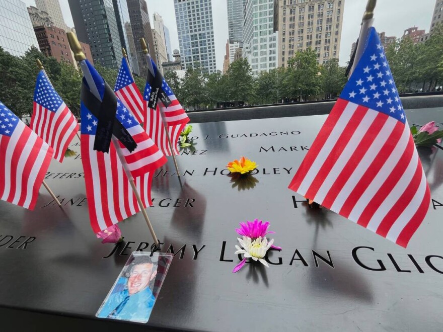 Flags and flowers are placed in the inscribed names at the National September 11 Memorial in New York on Wednesday, Sept. 10, 2025.
