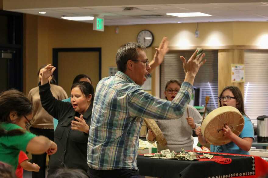 Seig̱óot Jessica Chester and Naakil.aan Hans Chester dance to Goosú Wa.é and donate money for a snack fund at Tlingit, Culture, Language and Literacy in Juneau on Oct. 30, 2025.