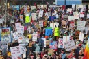 large crowd of people with protest signs