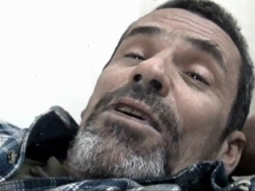 British photographer Paul Conroy lies on a stretcher as he is treated by a doctor in Homs on Feb. 22. Avaaz coordinated Conroy's rescue from the embattled city, an operation that left 13 Syrian activists dead.