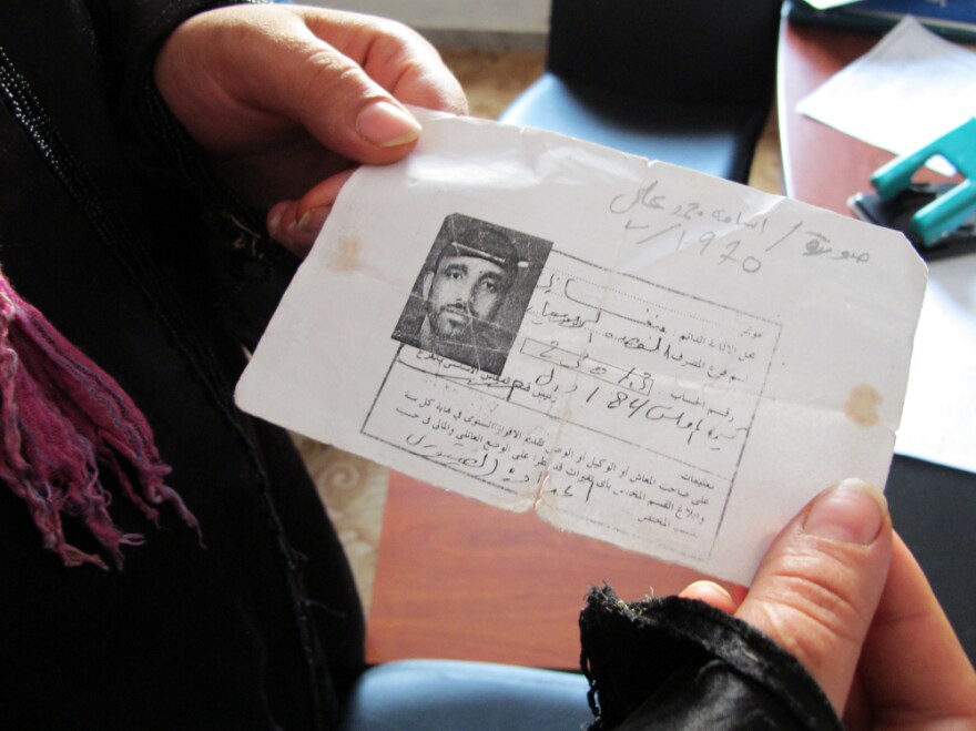 Mona Mohammed Ali holds a copy of her brother's identification card, found in the western town of Zawiya. He traveled to the town before the revolution began and became stuck there. Mohammed believes her brother is dead, but on Monday she came to the Red Crescent office seeking information.