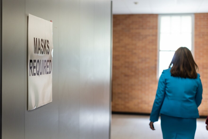  Austin ISD Superintendent Stephanie Elizalde walks passed a sign stating that masks are required on the first day of school at Travis High School on Aug. 17.